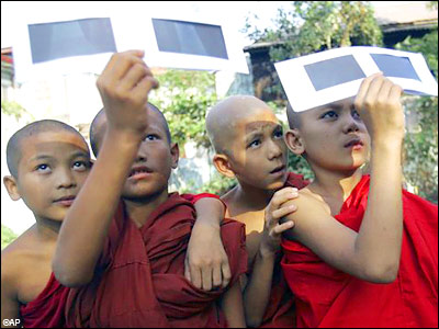Myanmar Buddhist novices watch solar eclipse through the filters in Yangon, Myanmar Myanmar Buddhist novices watch solar eclipse through the filters, in Yangon, Myanmar