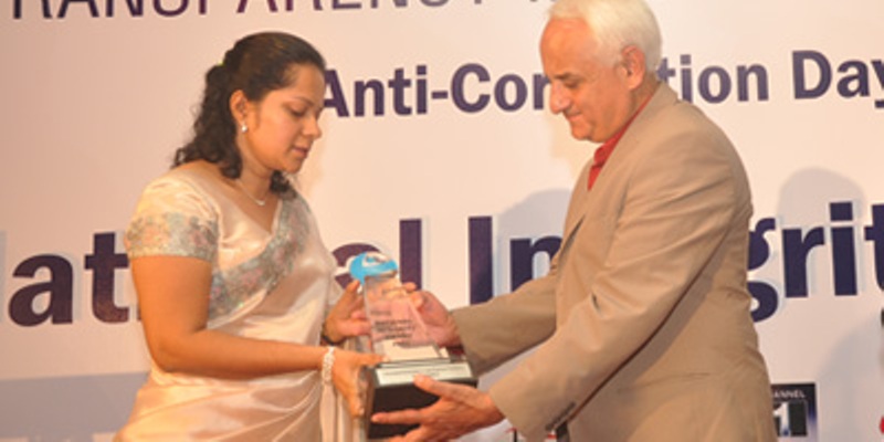 Angela Perera, wife of late Sujith Prasanna Perera, receives the award from Kanak Dixit