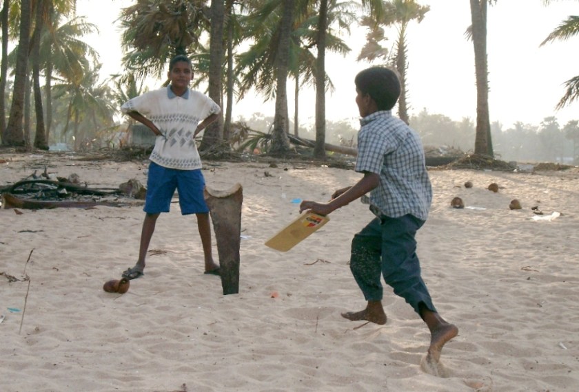 Sri Lanka - we lost family and property but life must go on - boys playing cricket on tsunami hit beach