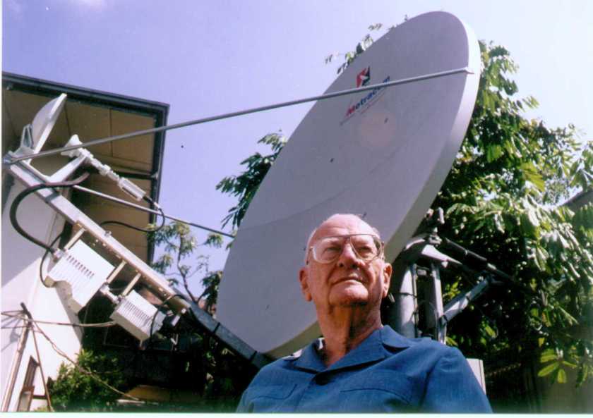 Sir Arthur Clarke next to satellite dish