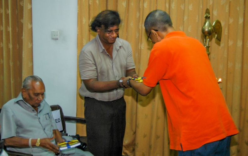 Nalaka presenting book to his science teacher & first publisher, Asanga Abeysundara