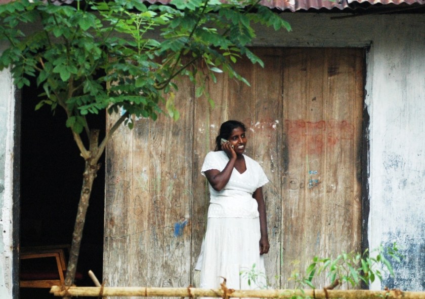 Rural woman in Sri Lanka using a mobile phone - Photo by Niroshan Fernando