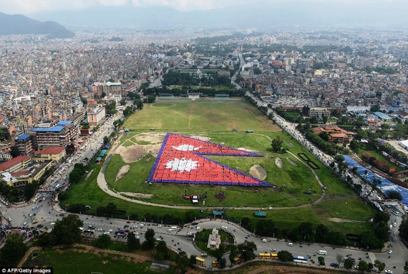 The Tudikhel open ground in central Kathmandu is transformed into a large flag holder as 35,000 Nepalese break the world record for the biggest human flag - 23 August 2014 - Photo by AFP/Getty Images
