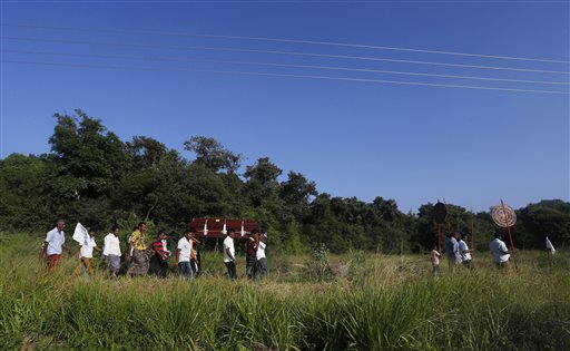 Villagers carry coffin containing body of Seneviratnalage Jayatillake, Lankan farmer who suffered from a mystery kidney disease, during his funeral in Padaviya Sri Lanka - Photo by Eranga Jayawwaardena, Associated Press